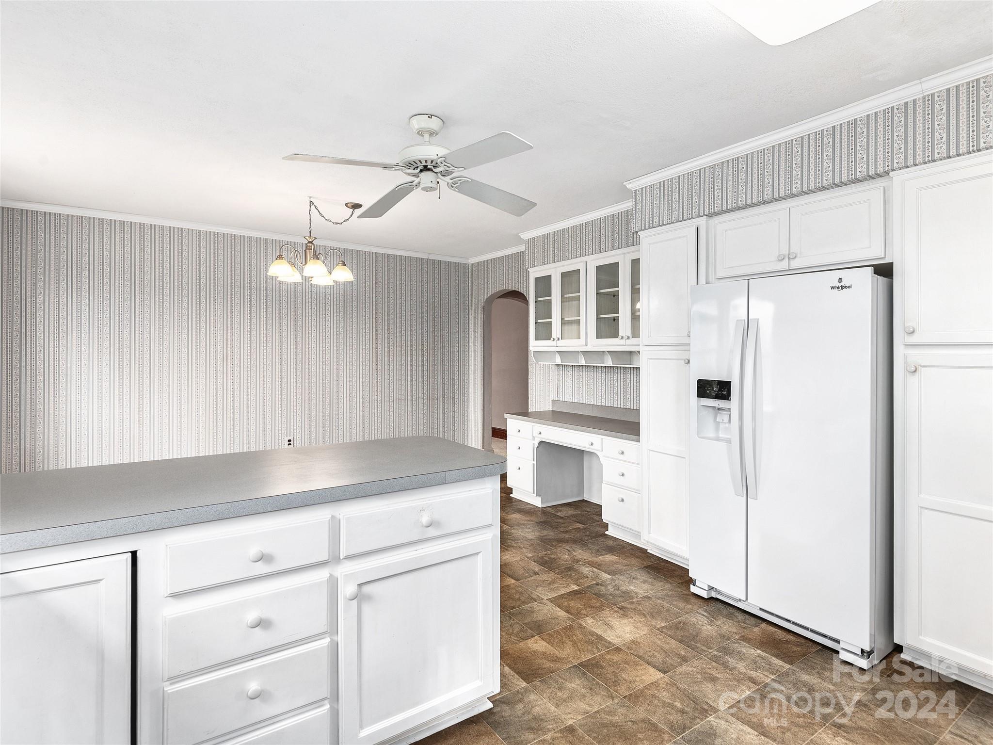 704 Mulberry Street Clyde, NC 28721 - Photo 7 of 36 a kitchen with a refrigerator a sink and dishwasher a oven with white cabinets