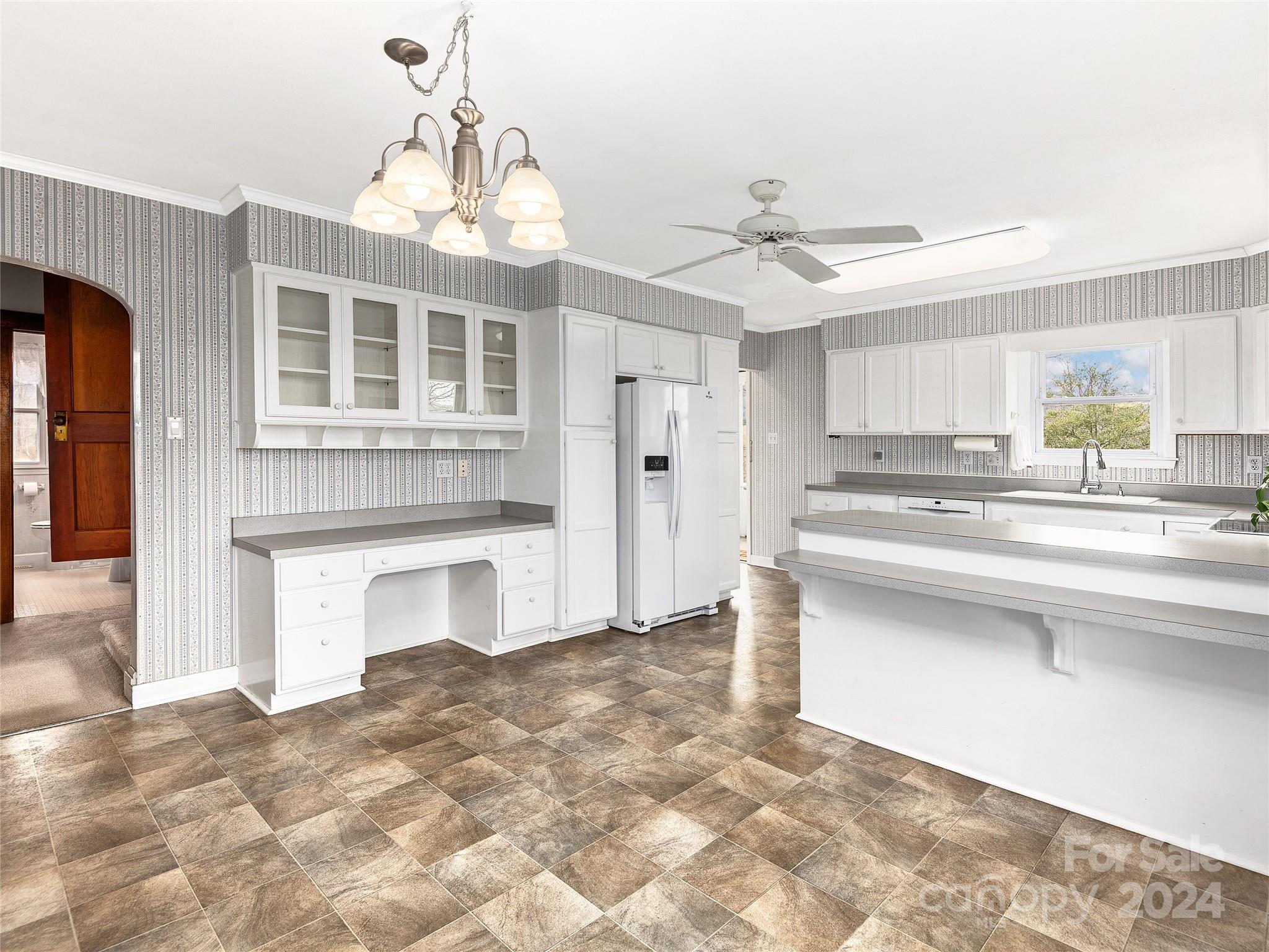 704 Mulberry Street Clyde, NC 28721 - Photo 9 of 36 a kitchen with stainless steel appliances granite countertop a stove a sink and a refrigerator