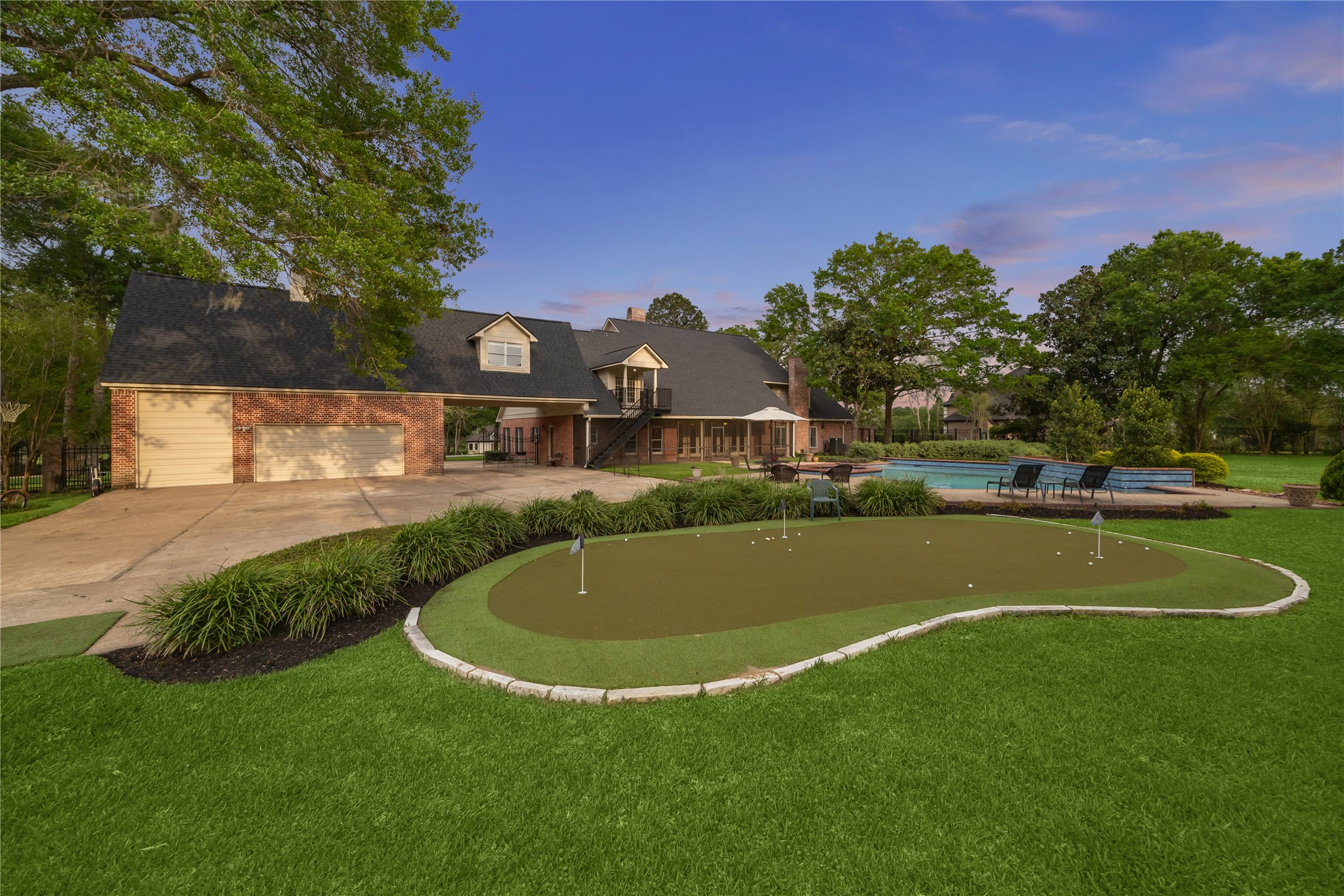 6611 Riva Ridge Drive Richmond, TX 77406 - Photo 42 of 46 Get in your golf practice daily with this custom oversized putting green with room to chip as well.