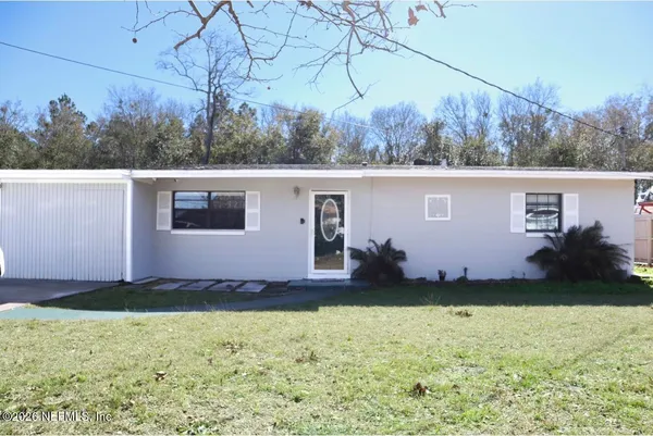 a view of a backyard with barn and large trees