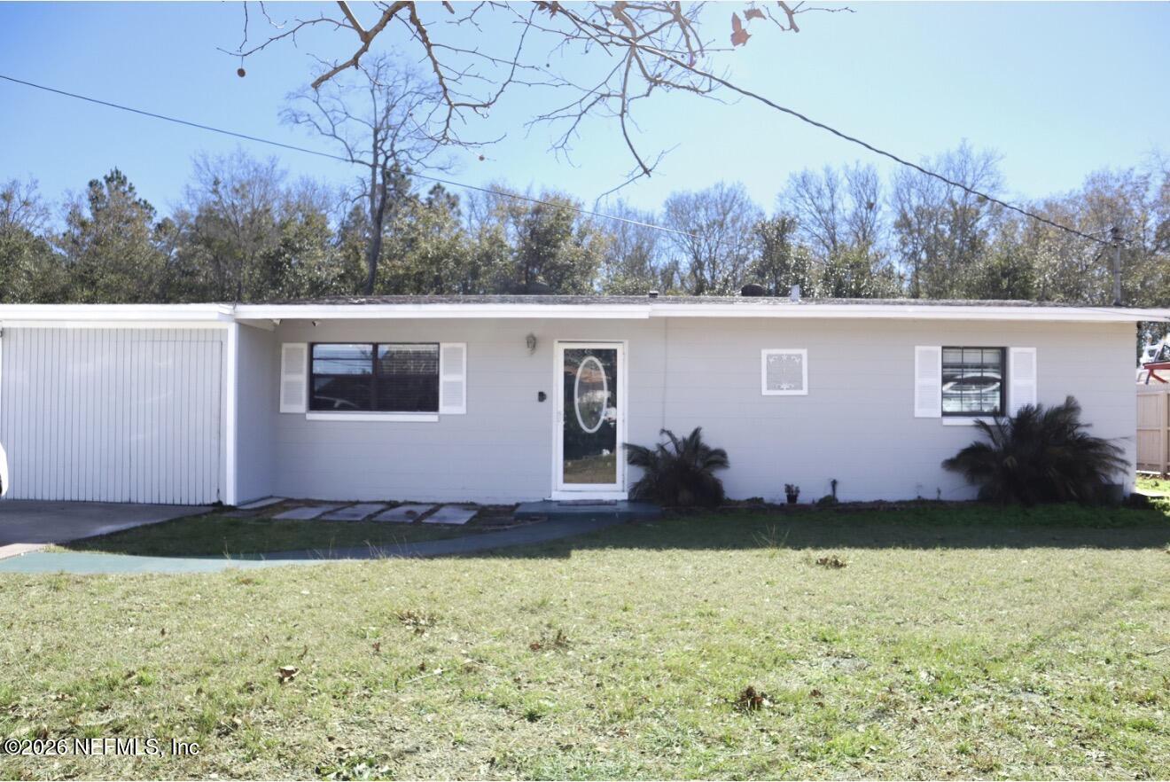 a view of a backyard with barn and large trees