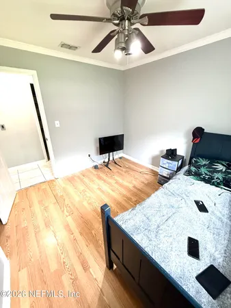 a bedroom with a bed and a chandelier