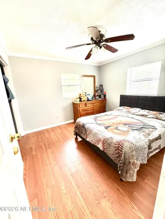 a bedroom with a bed and a ceiling fan
