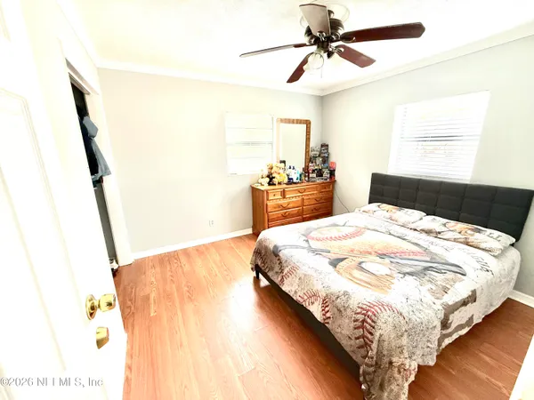 a bedroom with a bed and a mirror