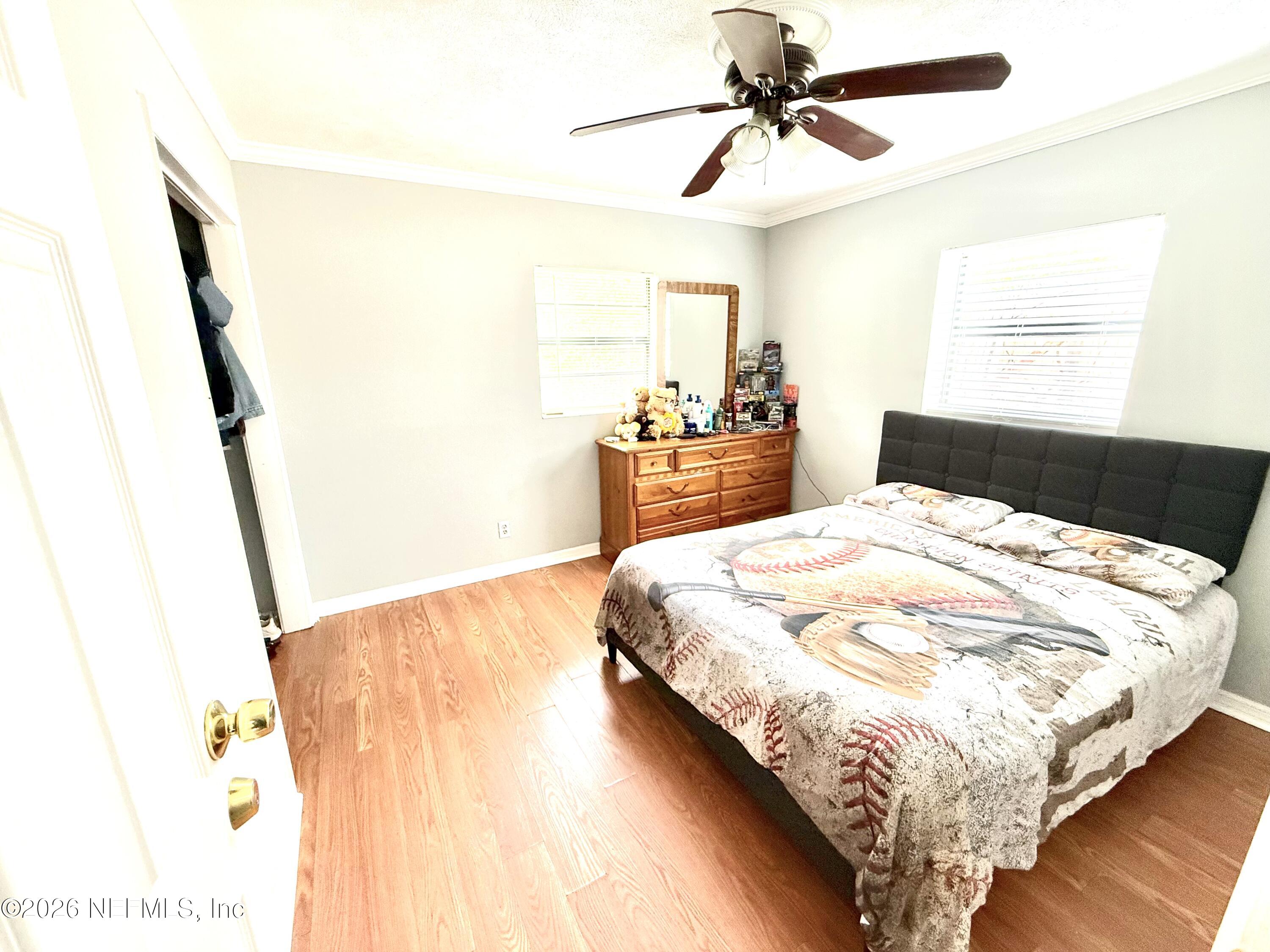 10162 Herndon Road Jacksonville, FL 32246 - Photo 16 of 31 a bedroom with a bed and a mirror