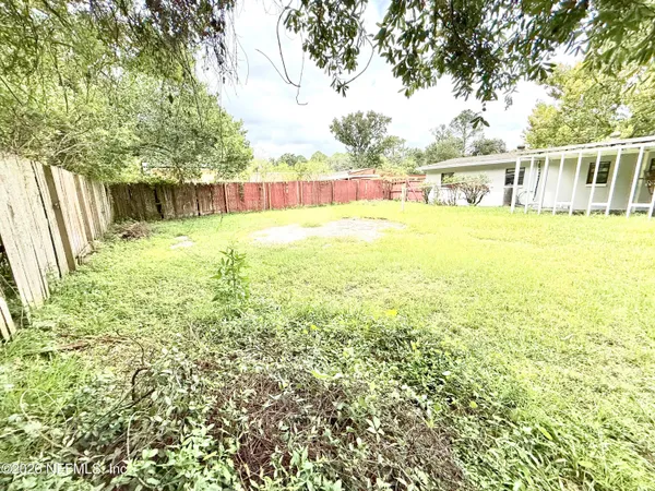 a view of a swimming pool with an outdoor seating and a yard