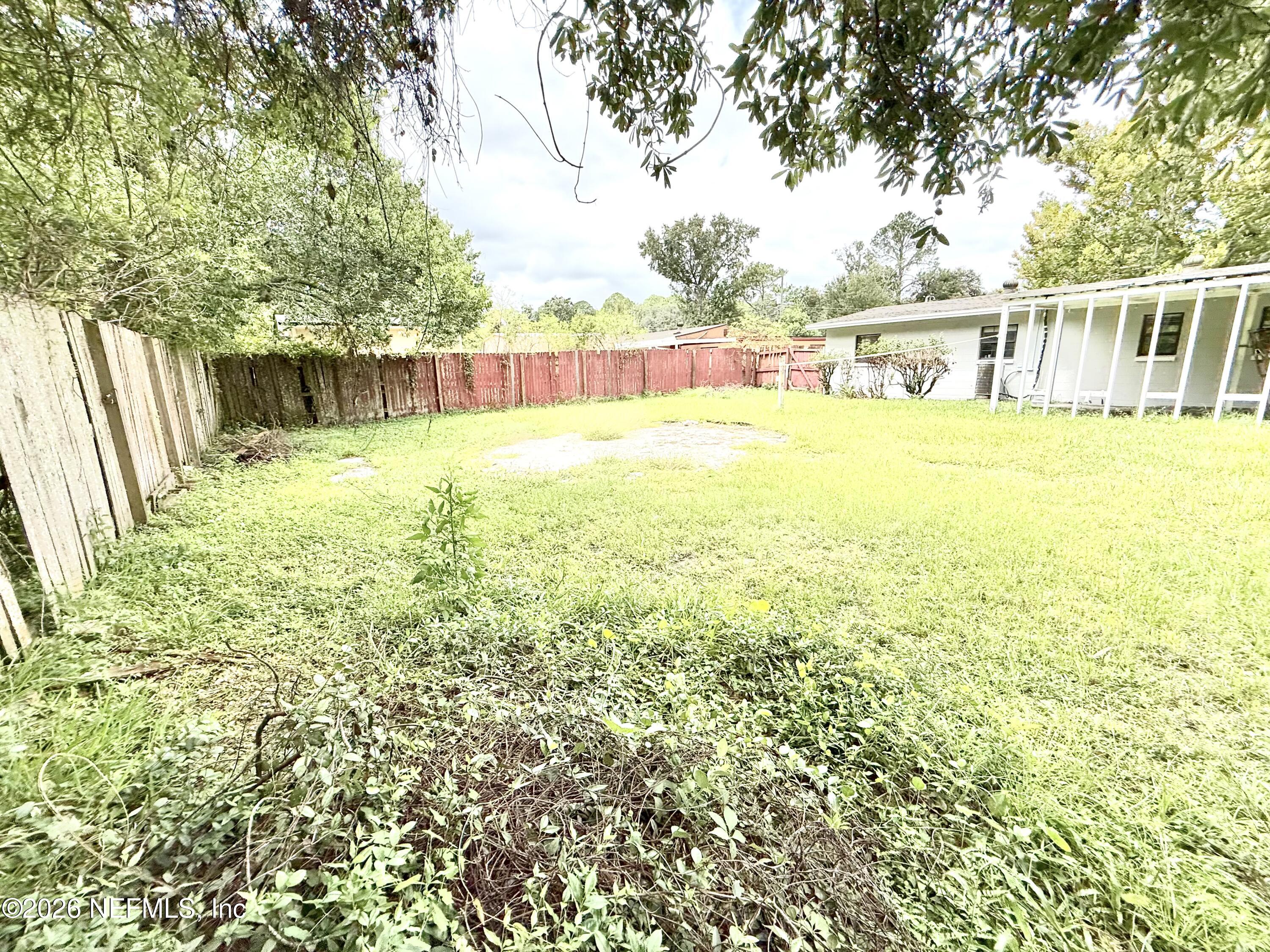 10162 Herndon Road Jacksonville, FL 32246 - Photo 21 of 31 a view of a swimming pool with an outdoor seating and a yard