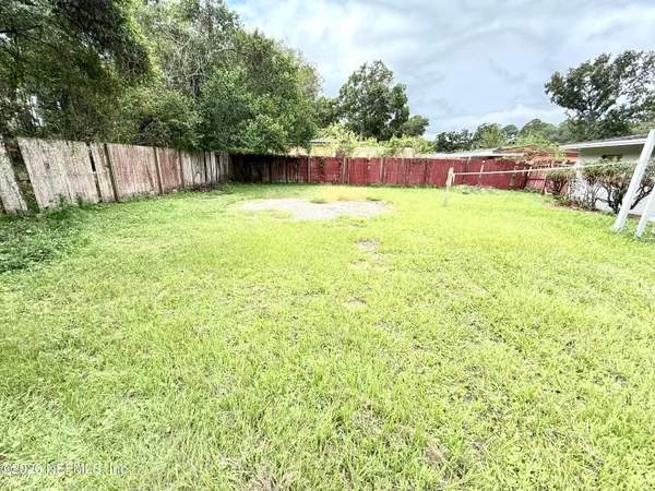 a view of swimming pool with a yard and fence