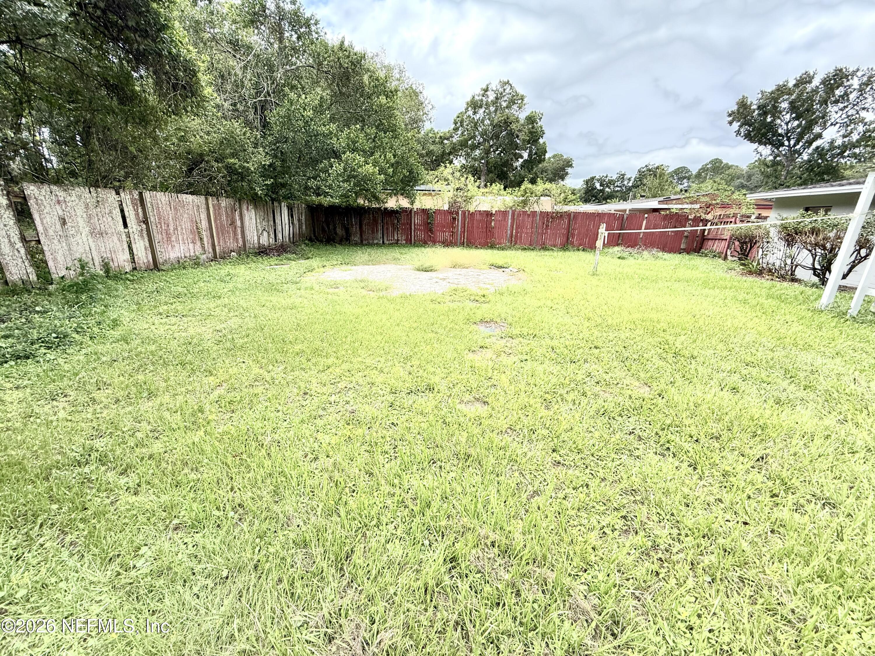 10162 Herndon Road Jacksonville, FL 32246 - Photo 24 of 31 a view of swimming pool with a yard and fence