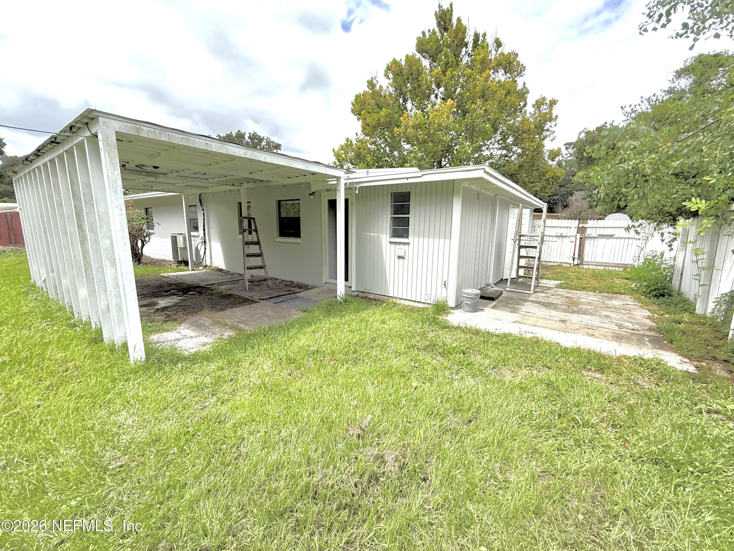 10162 Herndon Road Jacksonville, FL 32246 - Photo 25 of 31 a view of a house with a yard