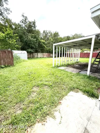 a view of a garden with a house