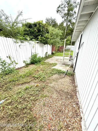 a view of a backyard with small cabin