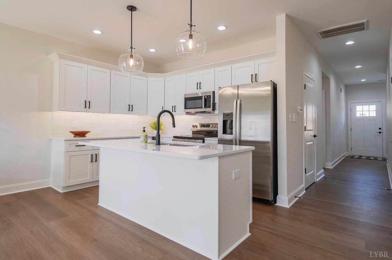 536 Leesville Road, Unit 303 Lynchburg, VA 24502 - Photo 2 of 34 a kitchen with kitchen island a sink stainless steel appliances and wooden floor