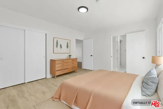 a bedroom with a bed and a lamp