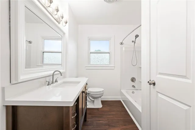 a bathroom with a sink a toilet a shower and a mirror