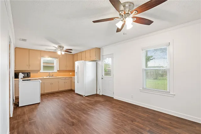 a kitchen with a refrigerator and a stove top oven