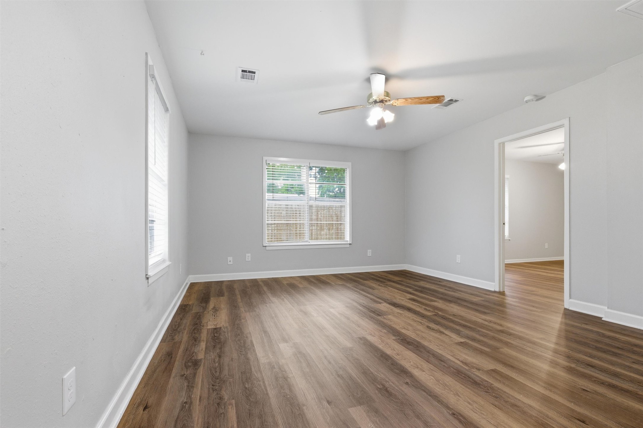 3615 Alberta Street Houston, TX 77021 - Photo 6 of 16 wooden floor in an empty room with a window