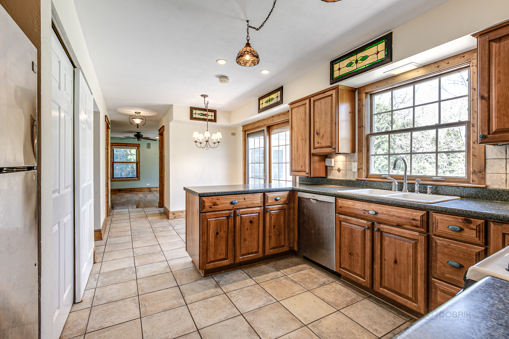 591 Surryse Road Lake Zurich, IL 60047 - Photo 11 of 33 a large kitchen with stainless steel appliances granite countertop a sink and cabinets