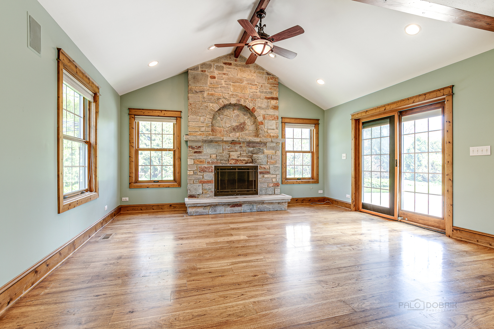 591 Surryse Road Lake Zurich, IL 60047 - Photo 14 of 33 an empty room with wooden floor fireplace and windows