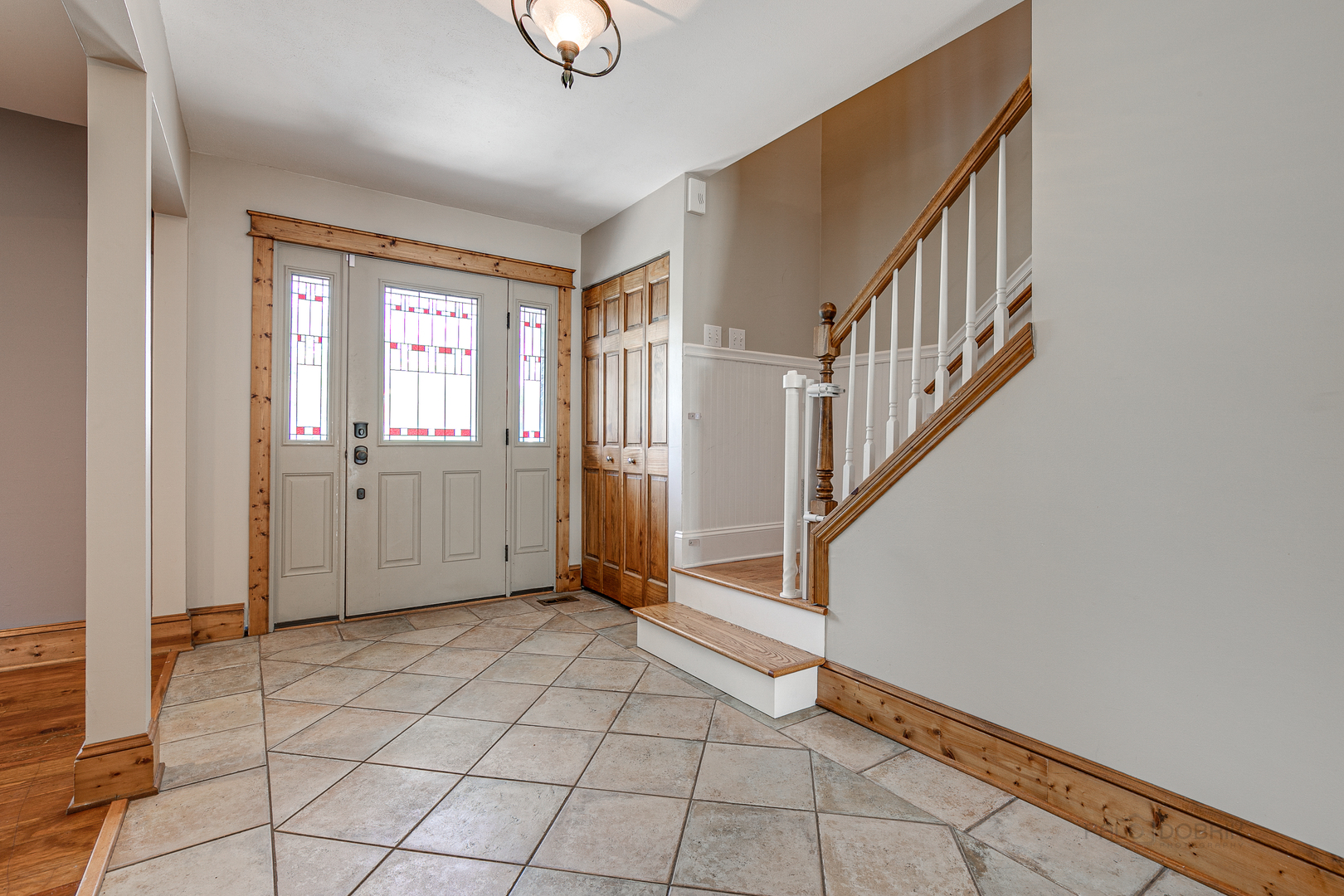 591 Surryse Road Lake Zurich, IL 60047 - Photo 3 of 33 a view of an entryway with wooden floor and windows
