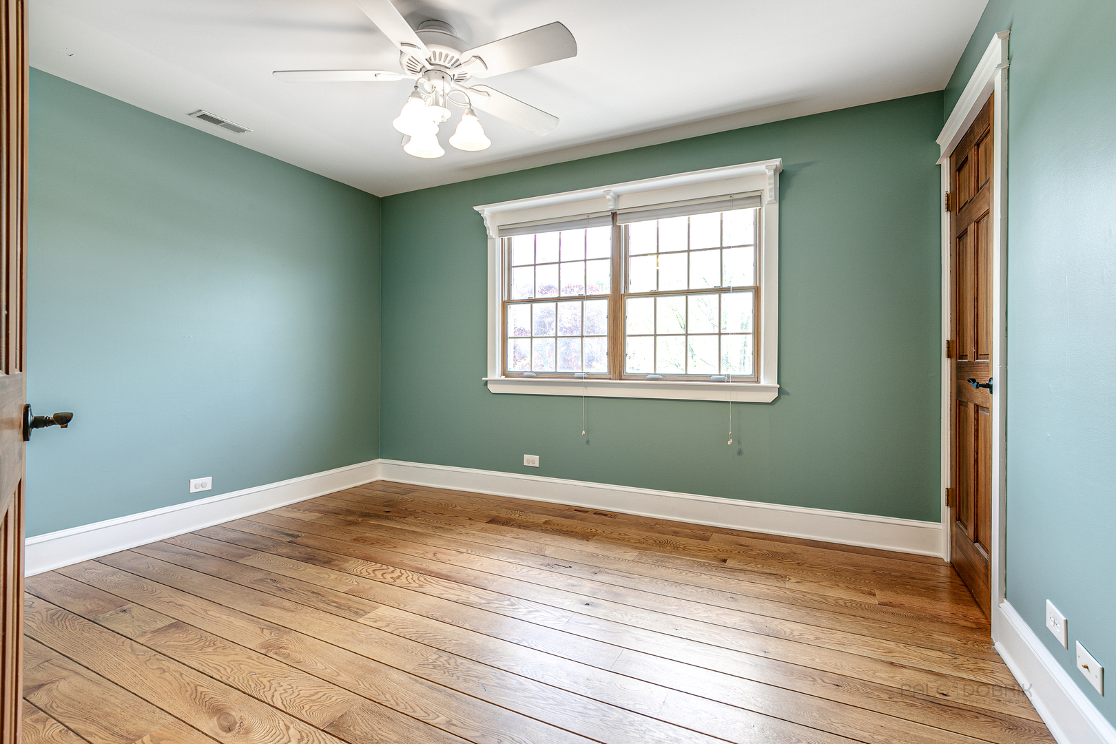 591 Surryse Road Lake Zurich, IL 60047 - Photo 23 of 33 an empty room with wooden floor and windows
