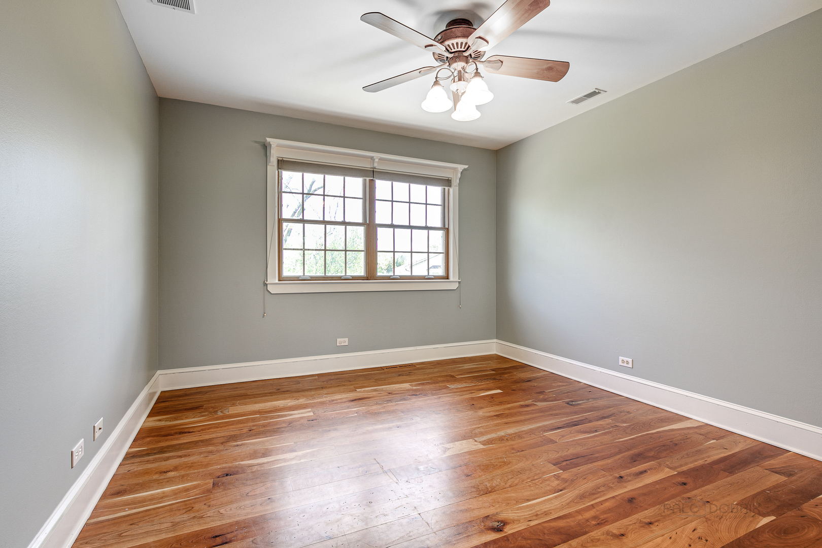591 Surryse Road Lake Zurich, IL 60047 - Photo 24 of 33 an empty room with wooden floor and windows