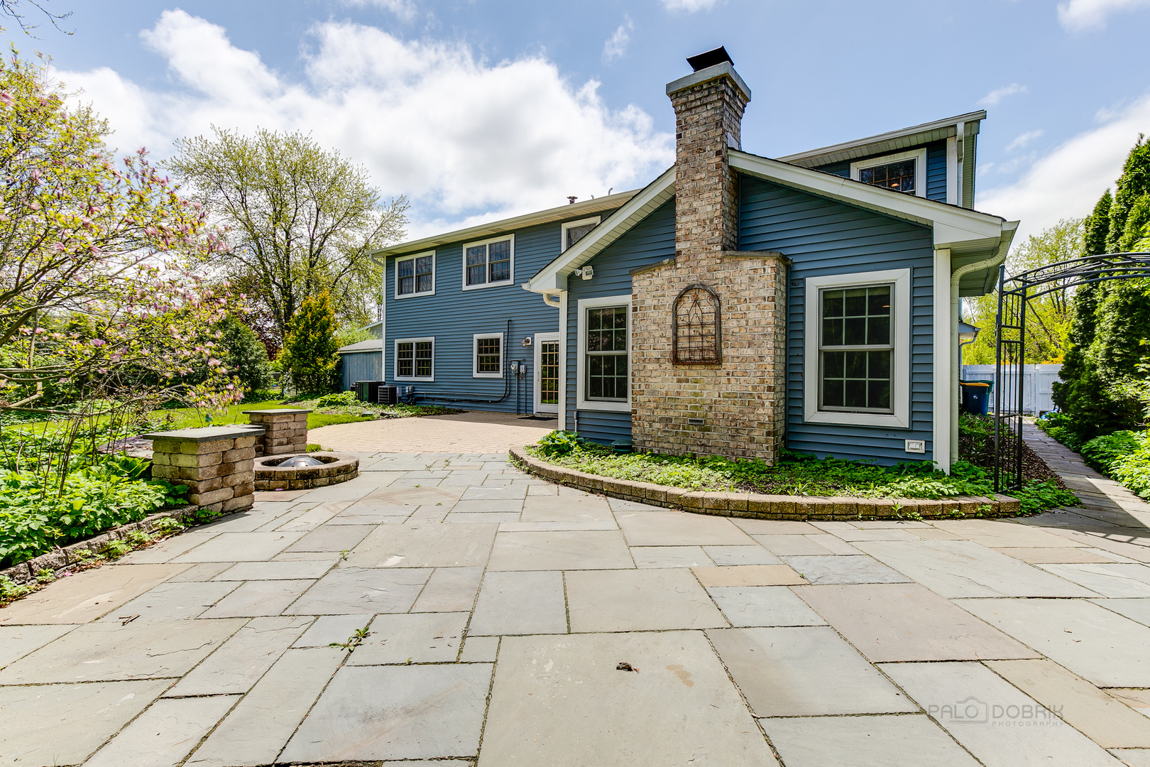 591 Surryse Road Lake Zurich, IL 60047 - Photo 28 of 33 a front view of a house with a yard and potted plants