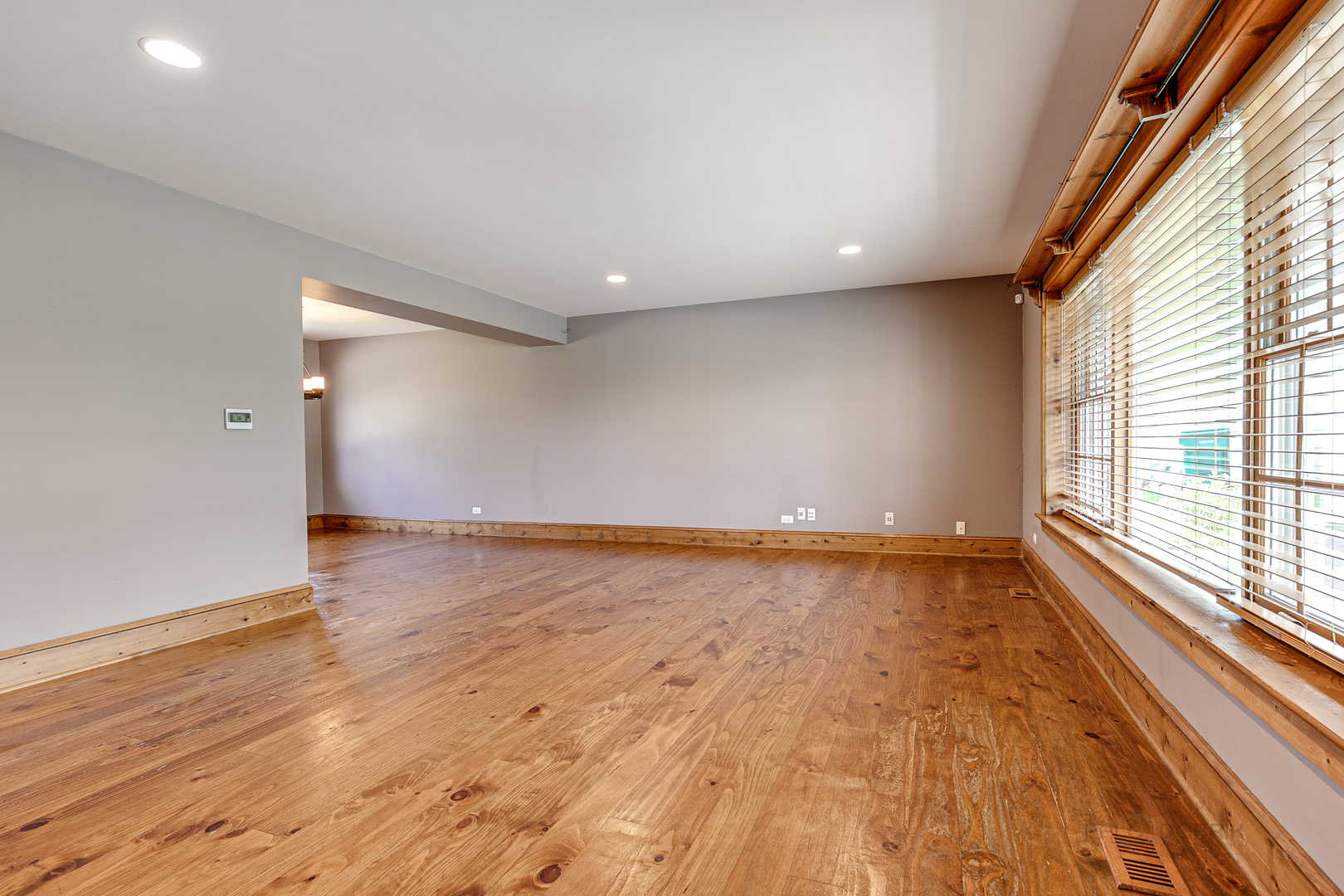 591 Surryse Road Lake Zurich, IL 60047 - Photo 5 of 33 wooden floor in an empty room with a window