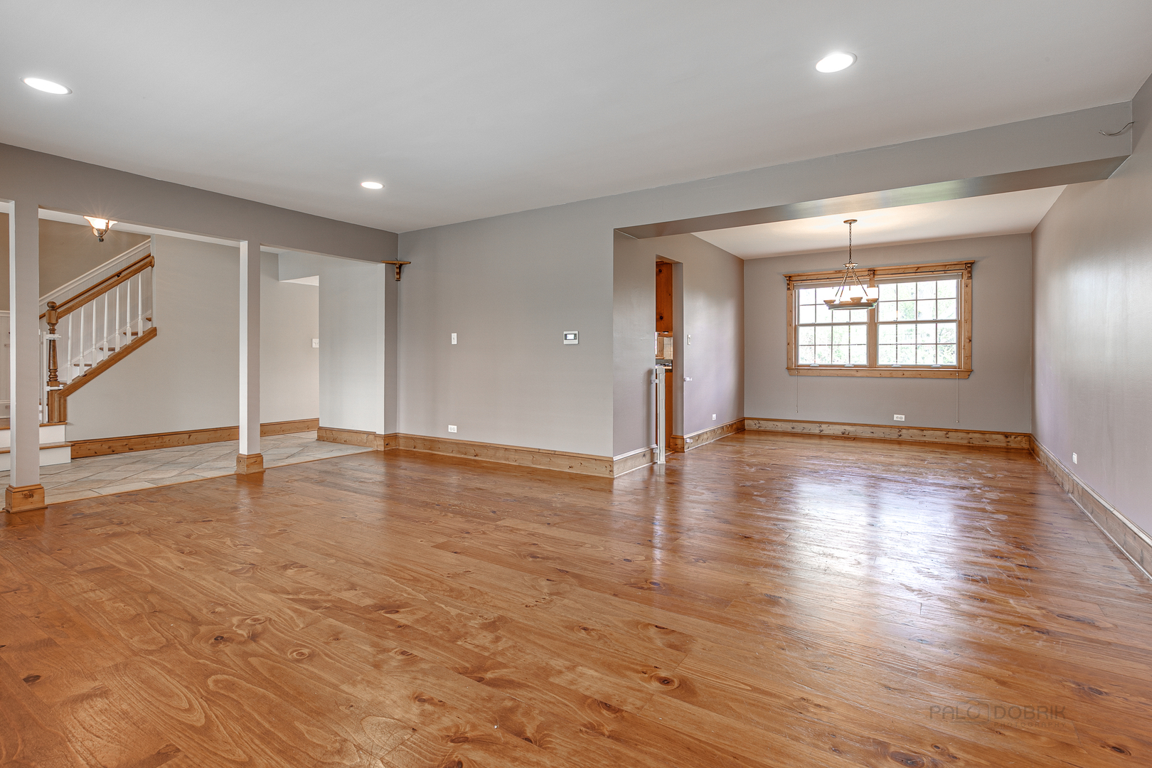 591 Surryse Road Lake Zurich, IL 60047 - Photo 6 of 33 an empty room with wooden floor and windows