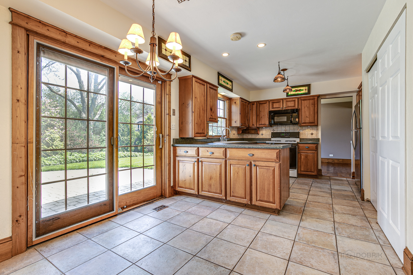 591 Surryse Road Lake Zurich, IL 60047 - Photo 9 of 33 a kitchen with a stove a sink dishwasher a refrigerator and cabinets