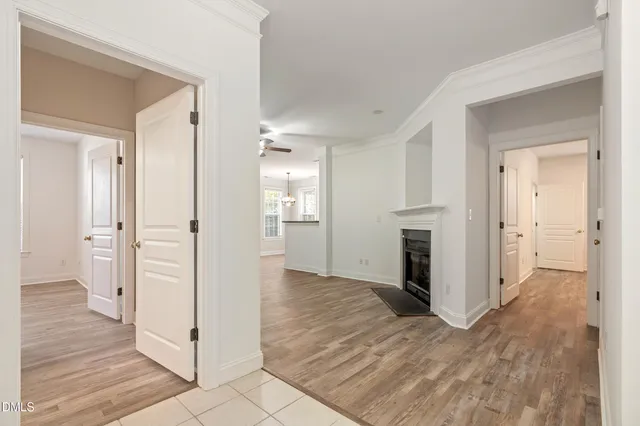 an empty room with wooden floor and entrance