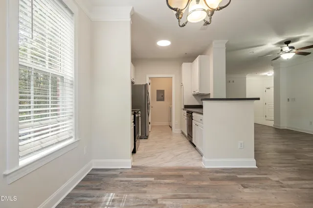 a view of a kitchen with a stove cabinets and wooden floor