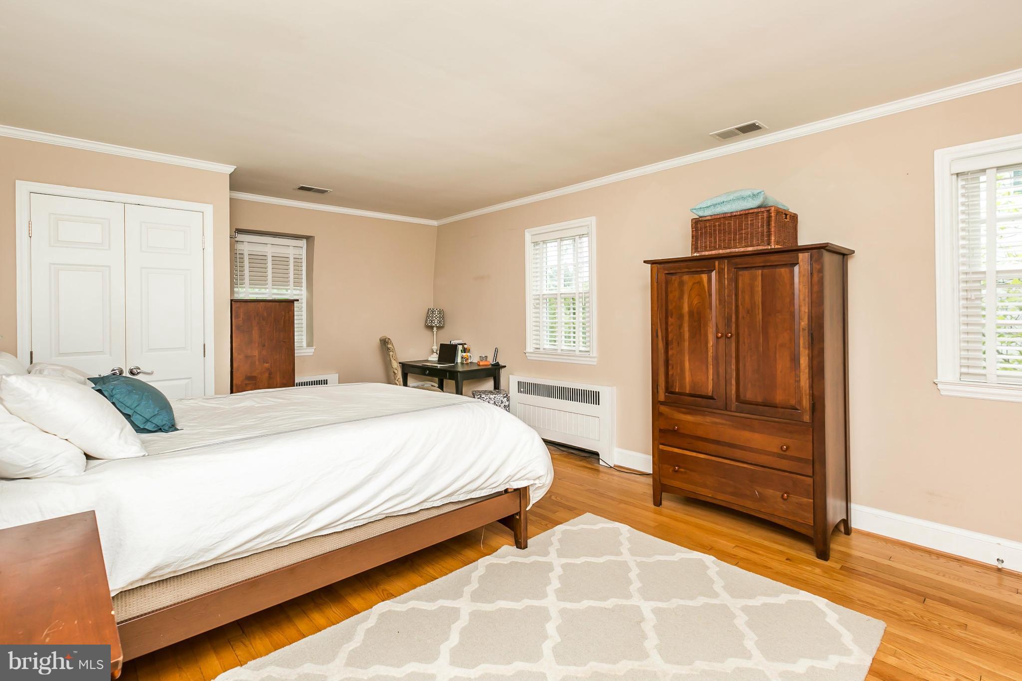5716 Kenmore Road Baltimore, MD 21210 - Photo 13 of 30 a spacious bedroom with a bed and a dresser