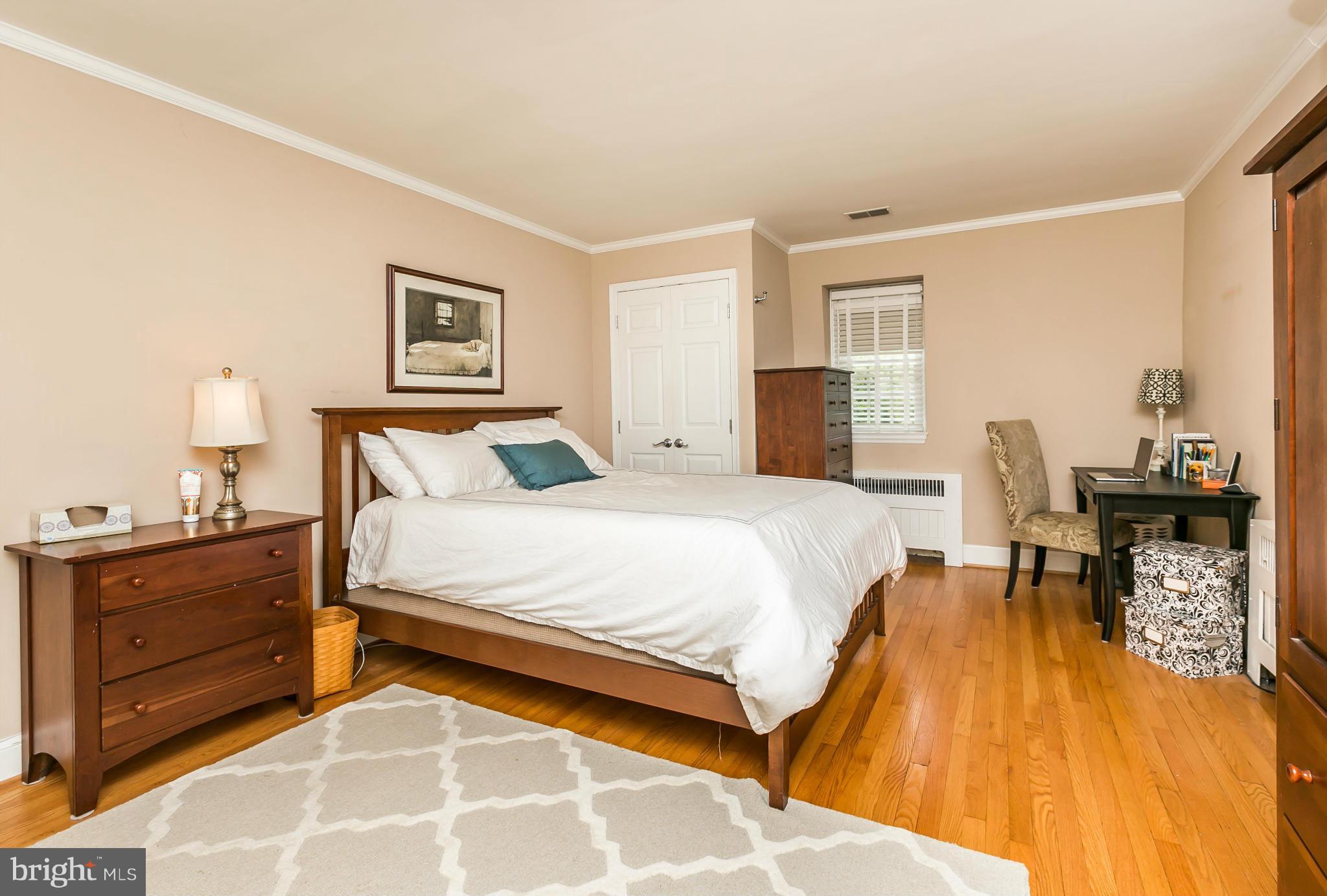 5716 Kenmore Road Baltimore, MD 21210 - Photo 14 of 30 a bedroom with a bed and wooden floor