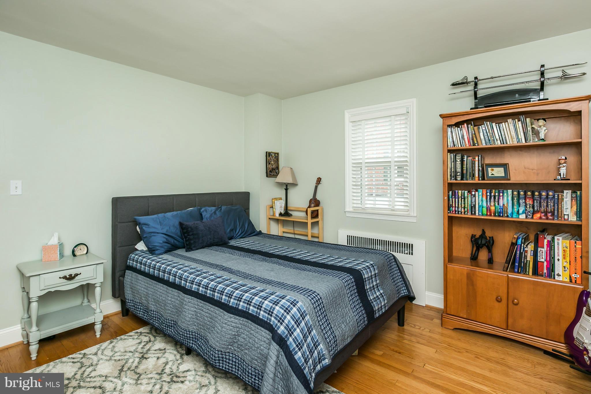 5716 Kenmore Road Baltimore, MD 21210 - Photo 17 of 30 a bedroom with a bed a dresser and book shelf