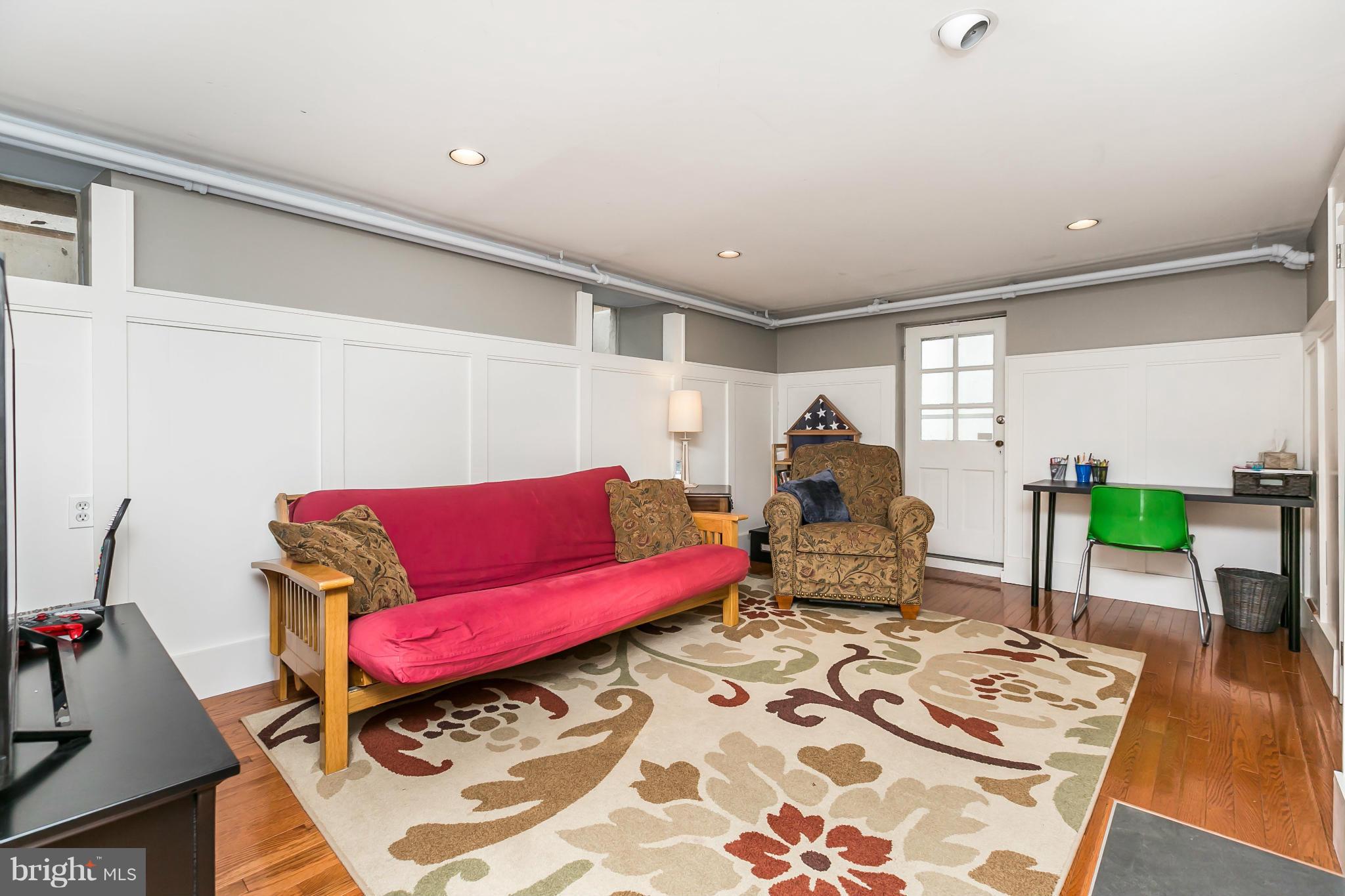 5716 Kenmore Road Baltimore, MD 21210 - Photo 18 of 30 a living room with furniture and wooden floor