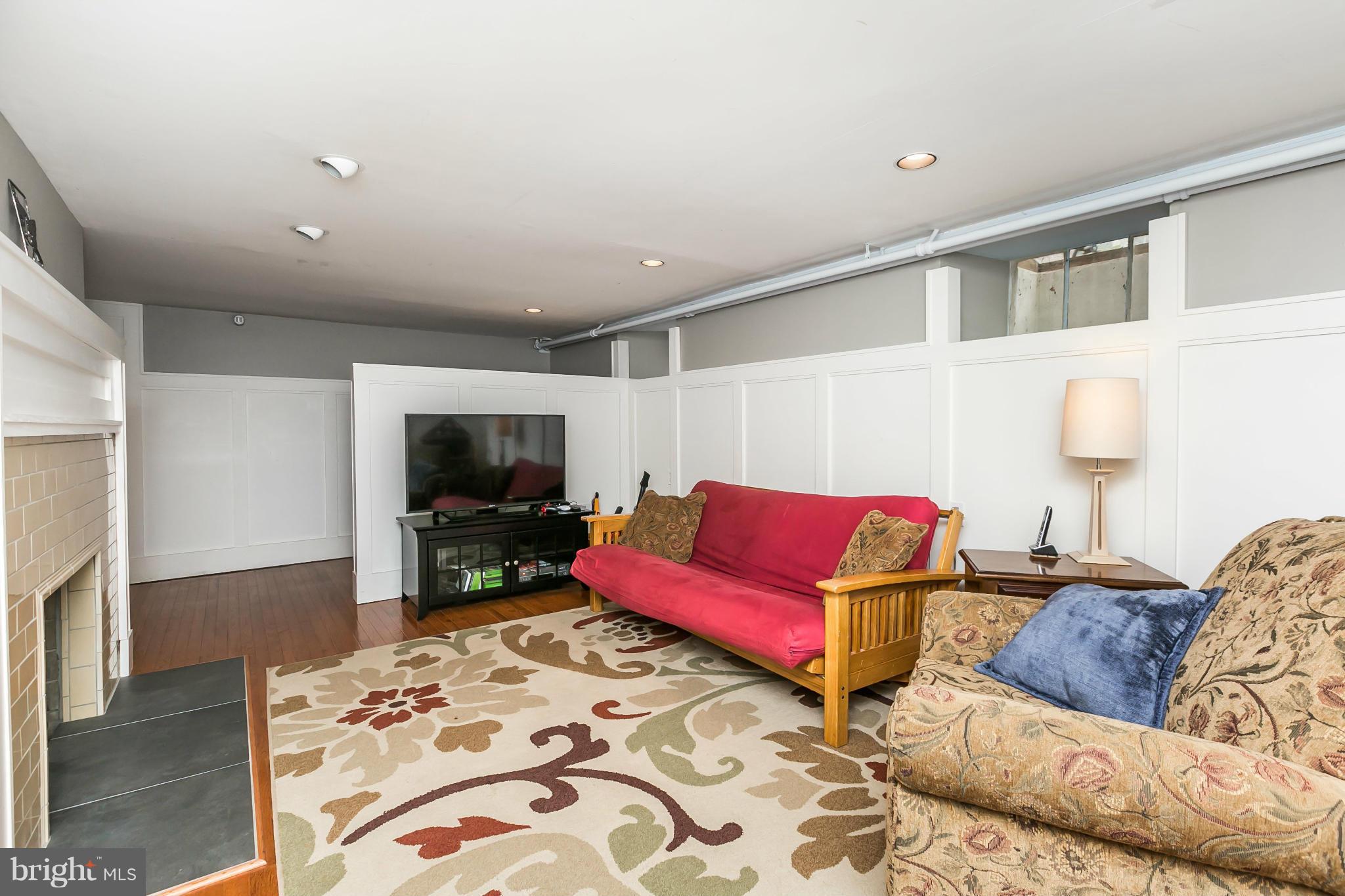 5716 Kenmore Road Baltimore, MD 21210 - Photo 19 of 30 a living room with furniture and a flat screen tv