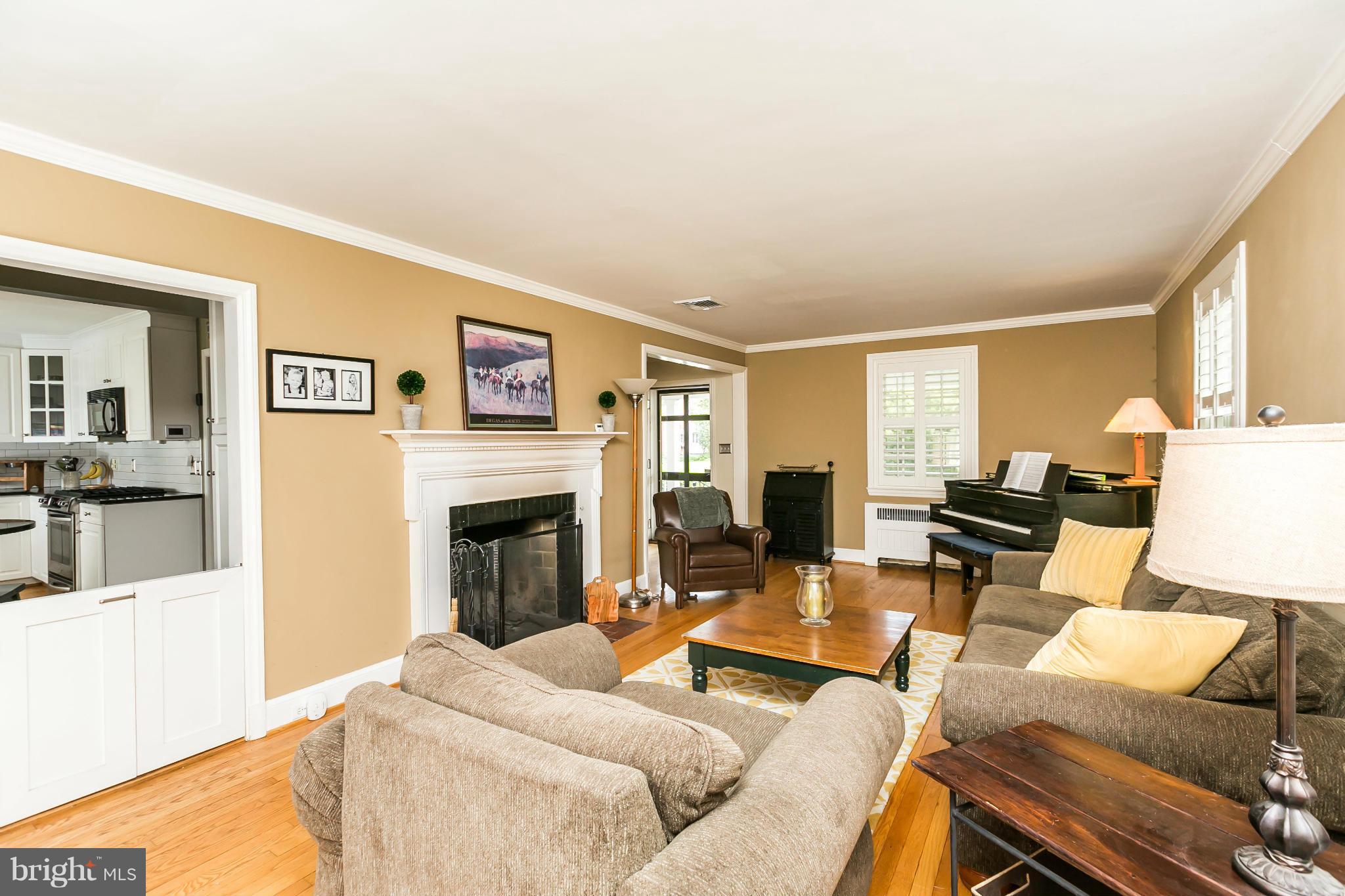 5716 Kenmore Road Baltimore, MD 21210 - Photo 4 of 30 a living room with furniture large window and a fireplace
