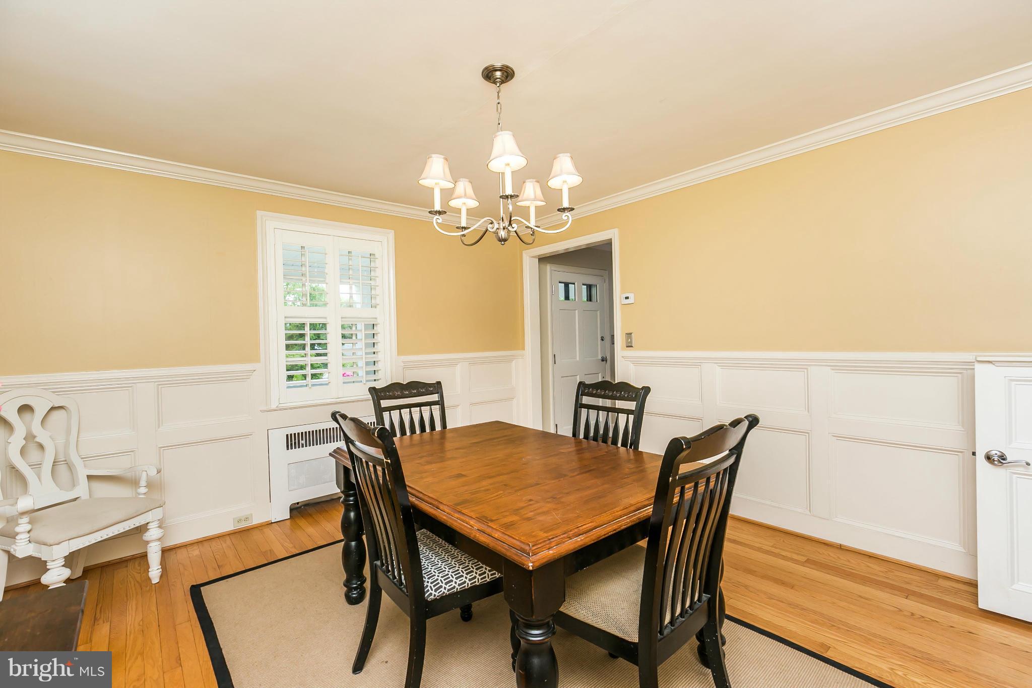 5716 Kenmore Road Baltimore, MD 21210 - Photo 5 of 30 a view of a dining room with furniture and a chandelier
