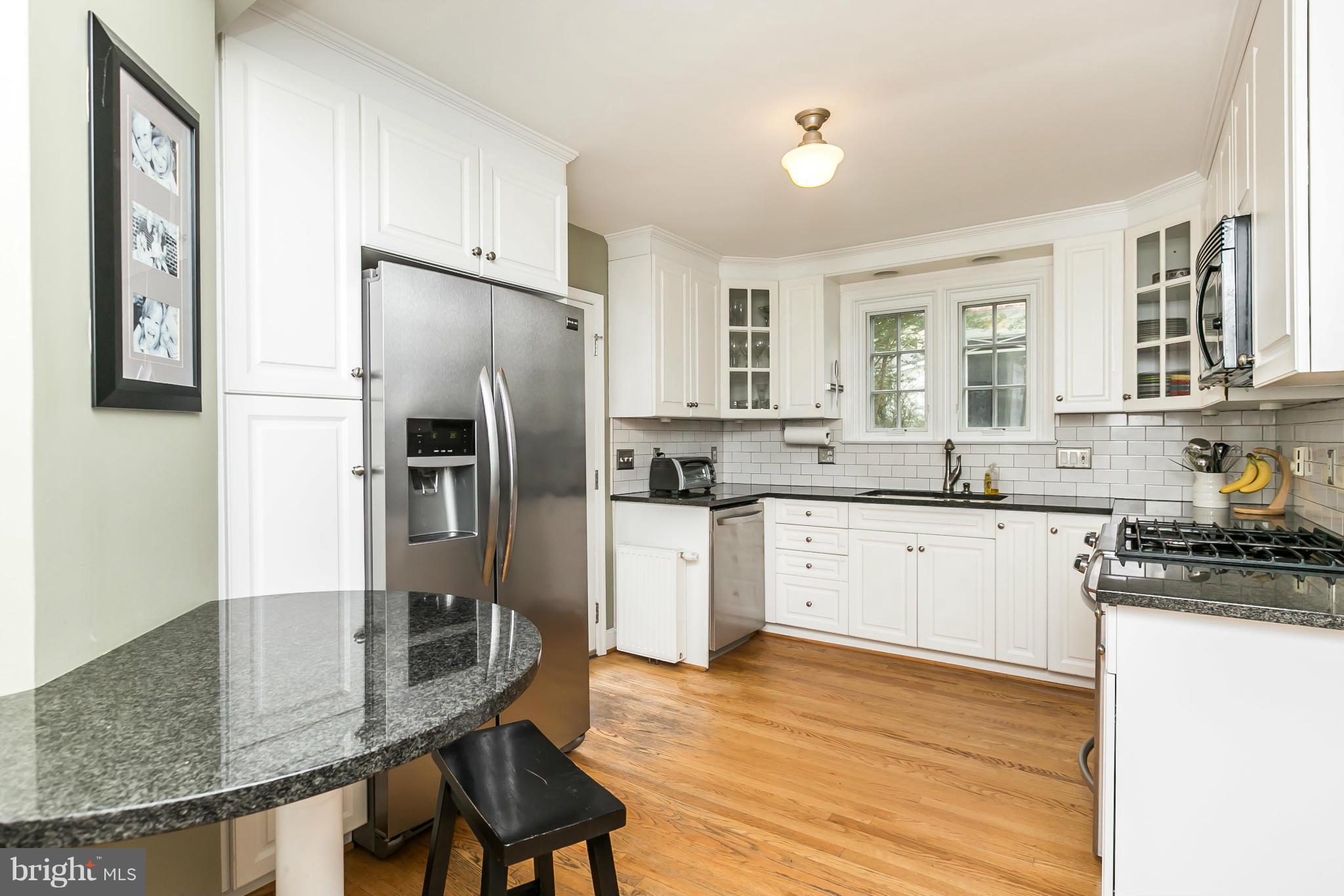 5716 Kenmore Road Baltimore, MD 21210 - Photo 7 of 30 a kitchen with granite countertop a refrigerator stove top oven and sink