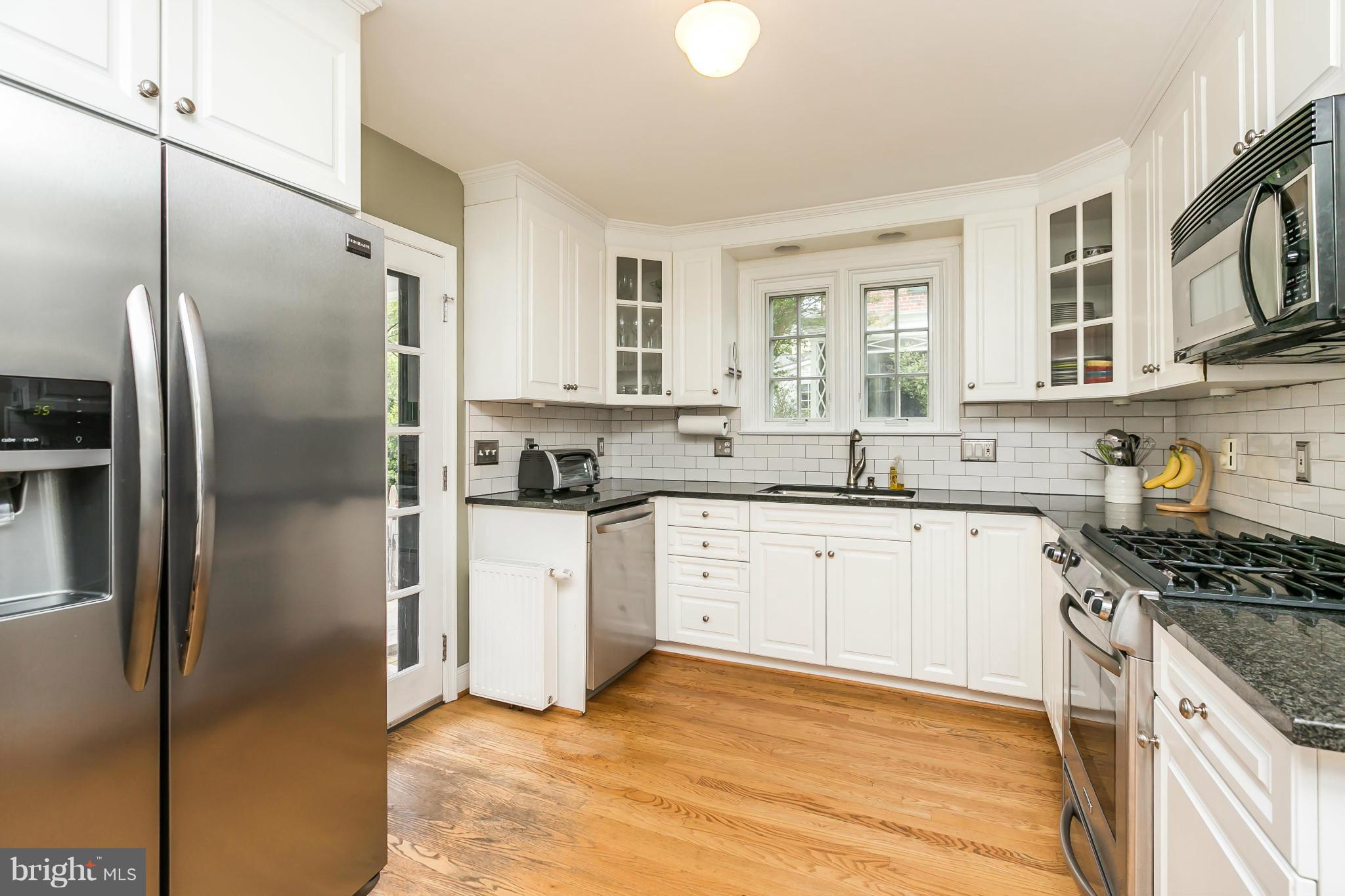 5716 Kenmore Road Baltimore, MD 21210 - Photo 8 of 30 a kitchen with stainless steel appliances granite countertop a refrigerator a stove and a sink