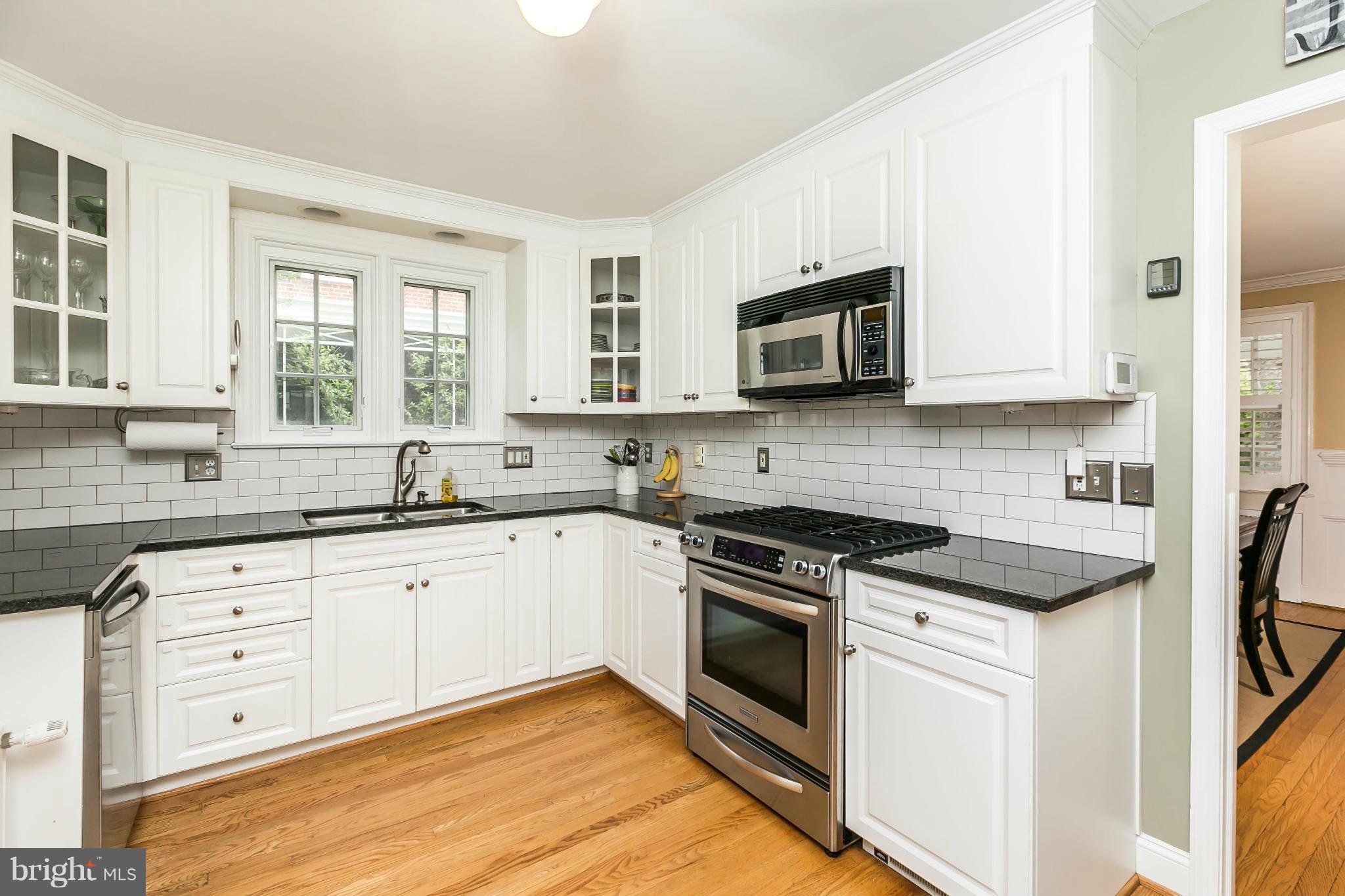 5716 Kenmore Road Baltimore, MD 21210 - Photo 9 of 30 a kitchen with granite countertop cabinets stainless steel appliances and a sink