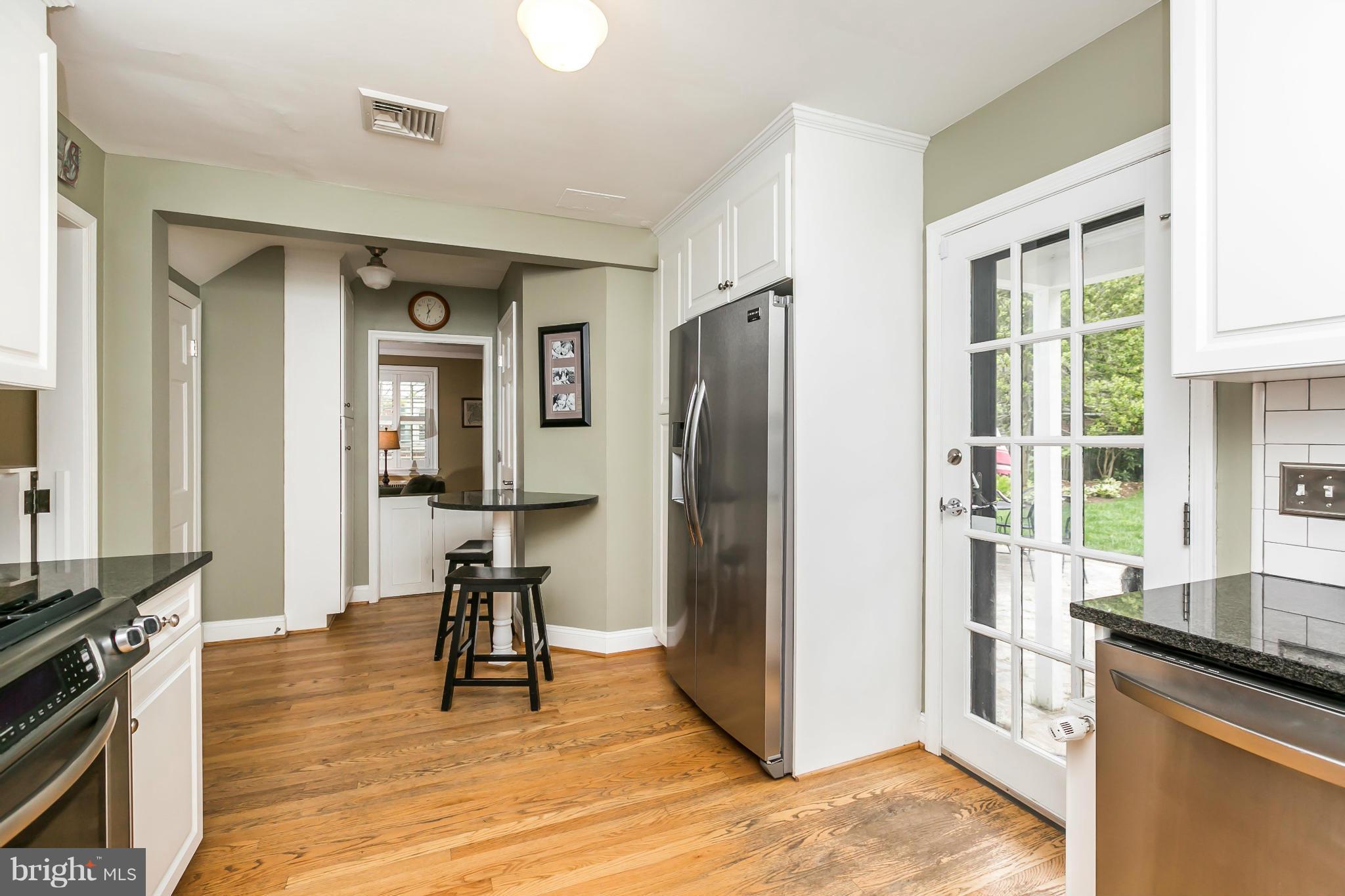 5716 Kenmore Road Baltimore, MD 21210 - Photo 10 of 30 a view of a kitchen with refrigerator and wooden floor