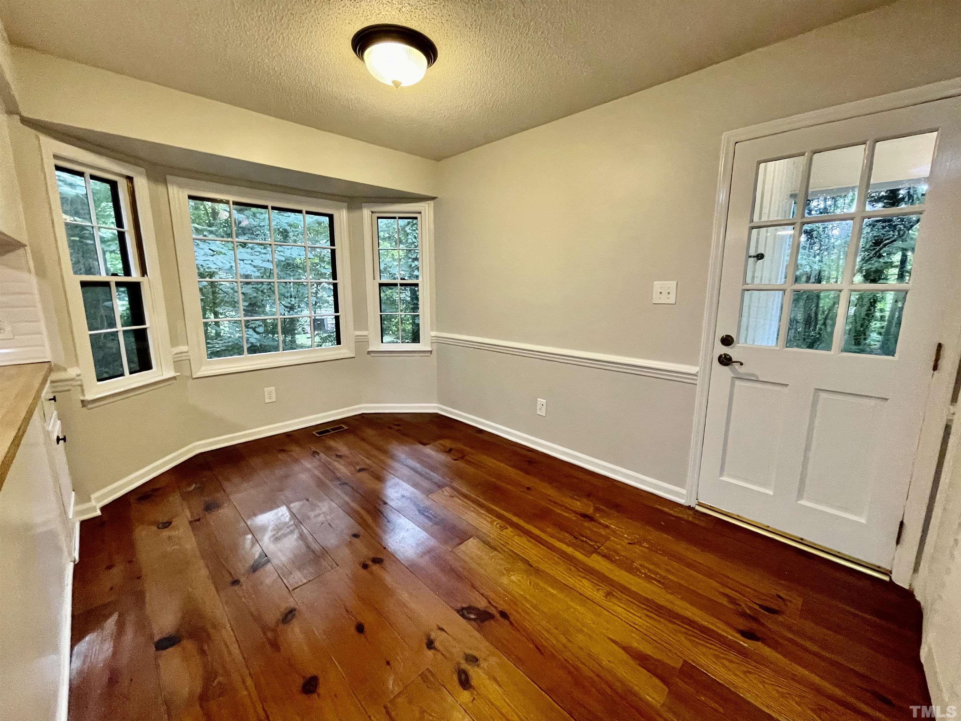 3100 Shadwell Court Raleigh, NC 27613 - Photo 12 of 30 an empty room with wooden floor and windows