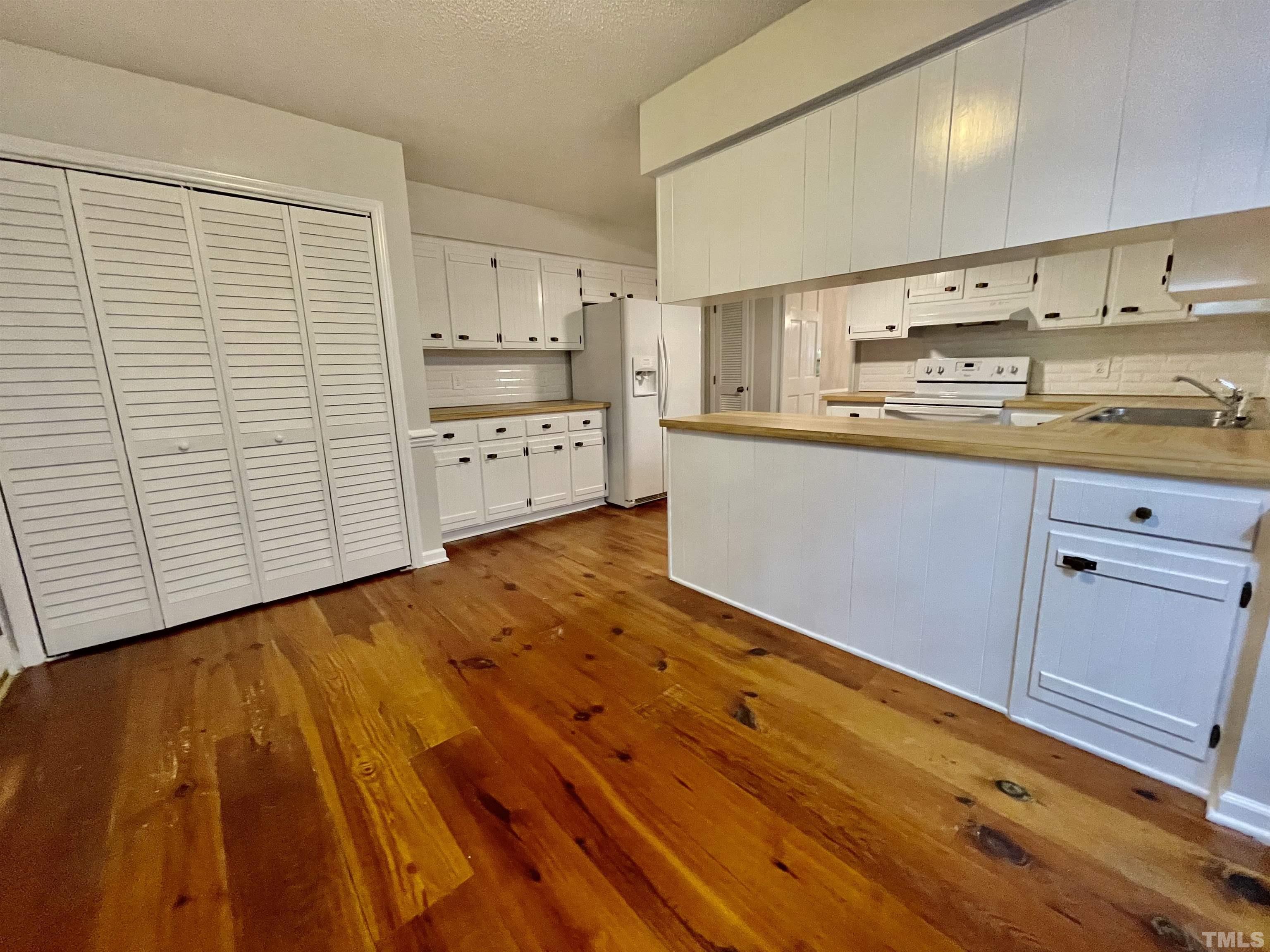3100 Shadwell Court Raleigh, NC 27613 - Photo 13 of 30 a kitchen with stainless steel appliances a sink and cabinets