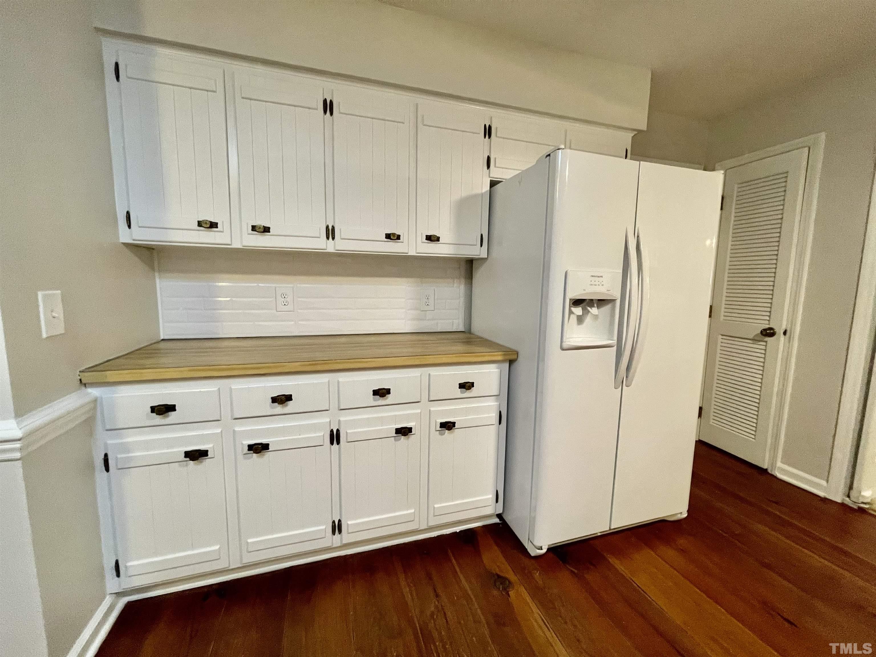 3100 Shadwell Court Raleigh, NC 27613 - Photo 14 of 30 a kitchen with granite countertop white cabinets and white appliances