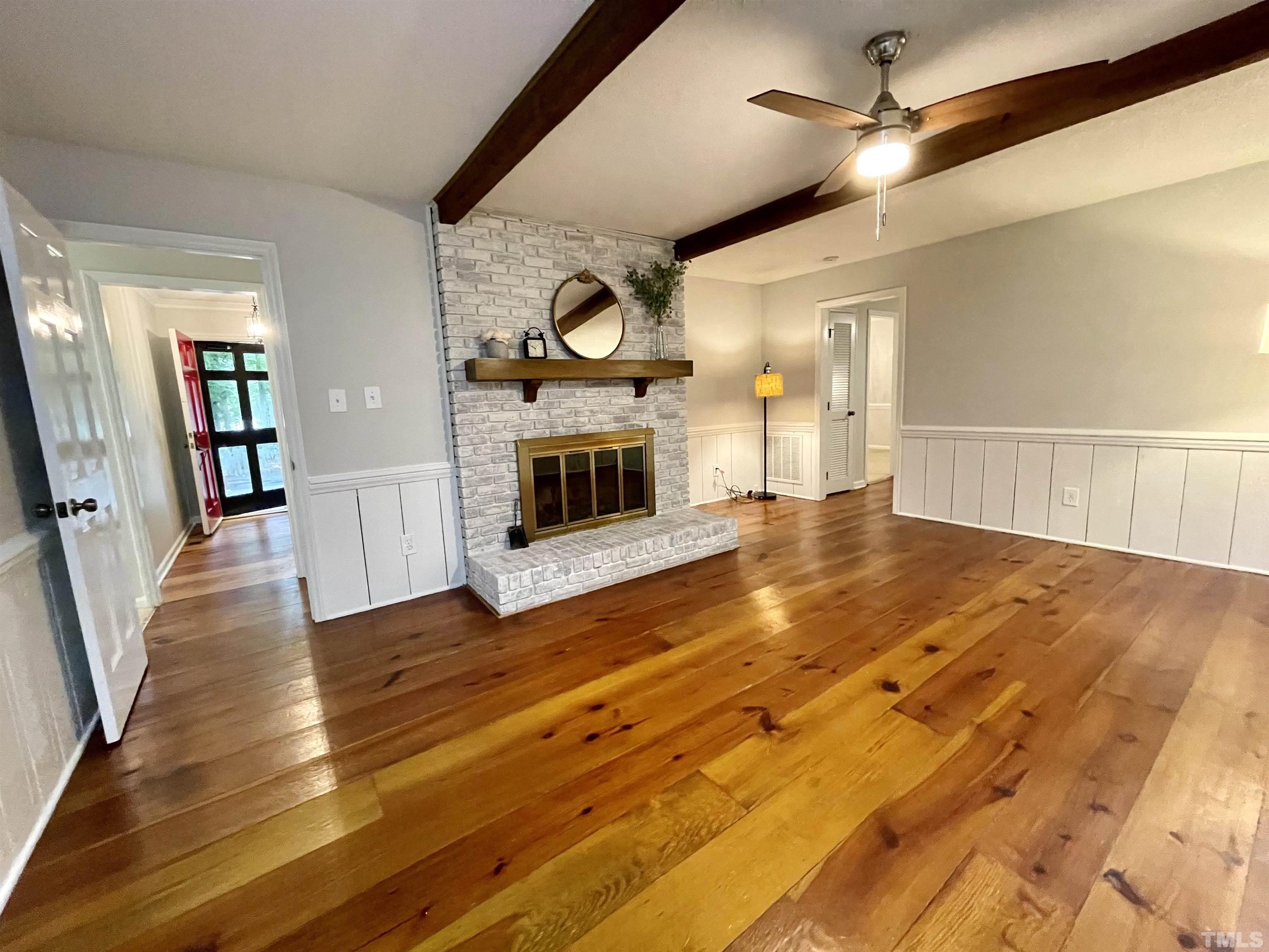 3100 Shadwell Court Raleigh, NC 27613 - Photo 17 of 30 wooden floor in an empty room with a fireplace