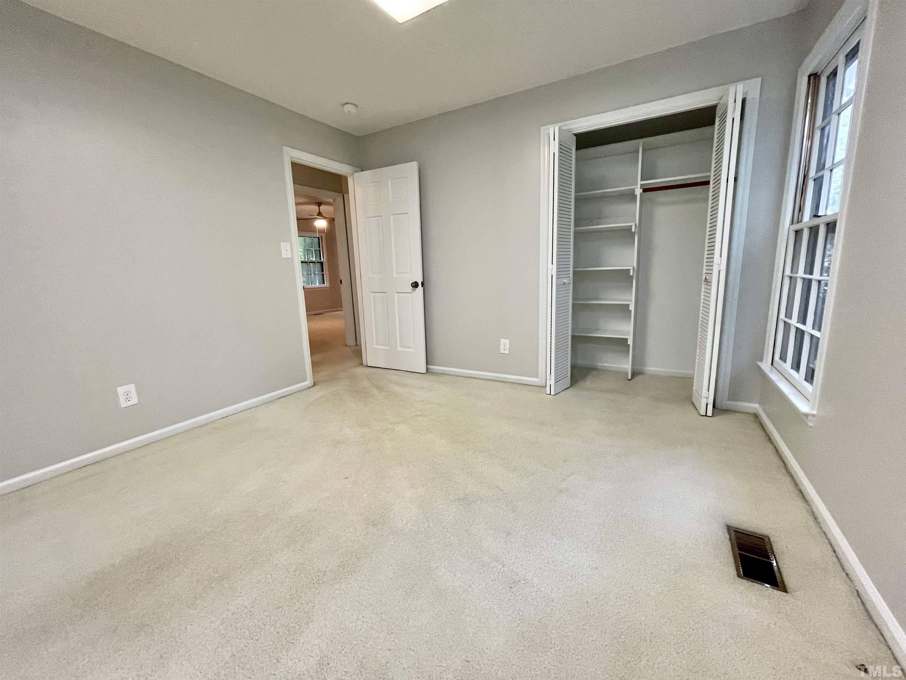 3100 Shadwell Court Raleigh, NC 27613 - Photo 27 of 30 an empty room with closet and windows