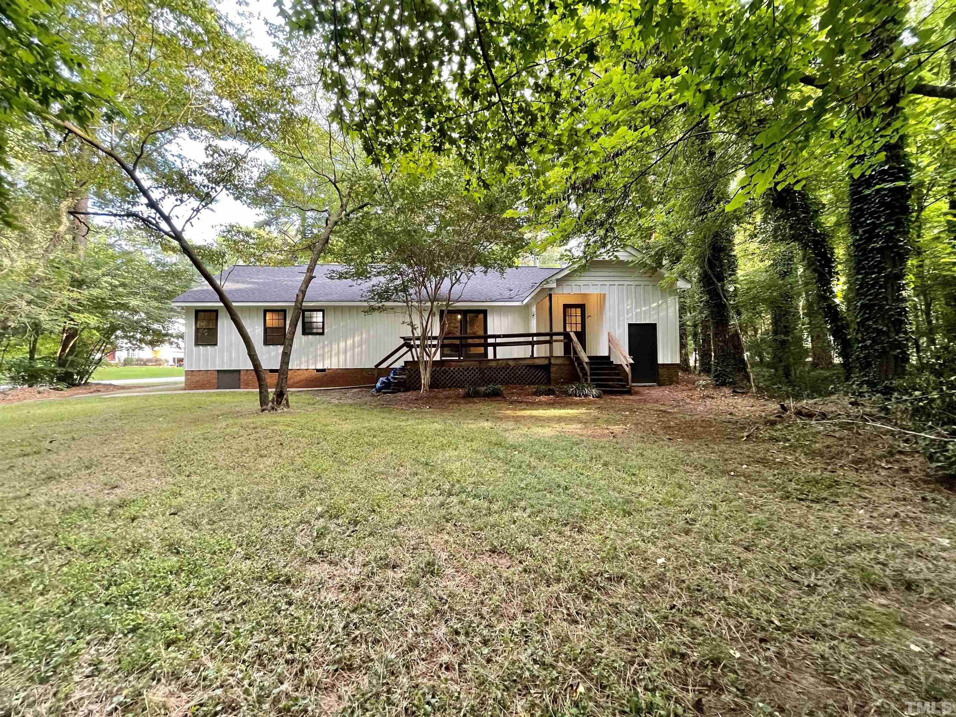 3100 Shadwell Court Raleigh, NC 27613 - Photo 30 of 30 a front view of a house with a garden and trees