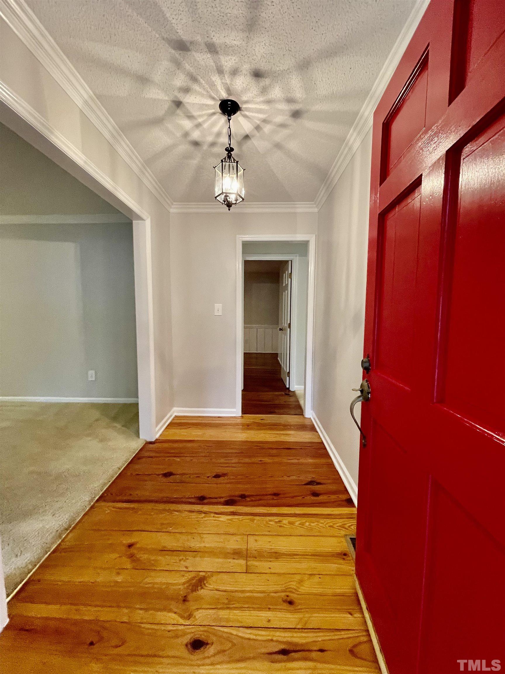 3100 Shadwell Court Raleigh, NC 27613 - Photo 5 of 30 a view of a hallway with a chandelier